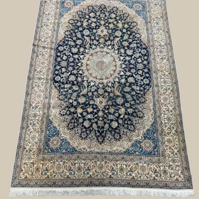 Elegant blue and ivory round rug featuring an ornate central medallion surrounded by detailed floral elements and a decorative border.