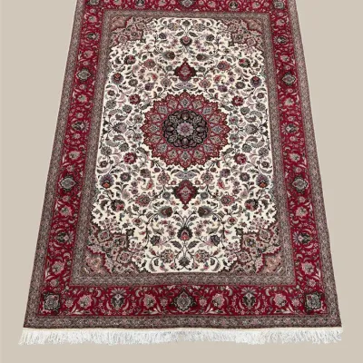 Ivory and burgundy traditional rug featuring an elaborate circular medallion surrounded by detailed floral motifs and a rich red border.