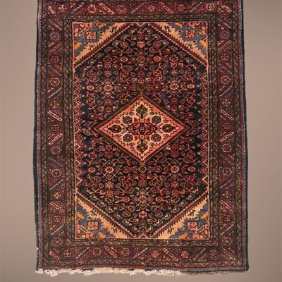 Dark red and navy geometric rug featuring a bold diamond-shaped central medallion and intricate patterned border.