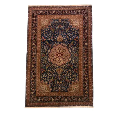 Dark blue and rust traditional rug featuring an ornate central medallion, floral detailing, and a richly patterned decorative border.