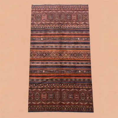 Earth-tone striped rug featuring intricate woven geometric bands in rust, brown, blue, ivory, and muted orange.