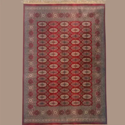 Mauve and burgundy traditional rug featuring repeating oval medallions framed by an intricate decorative border.