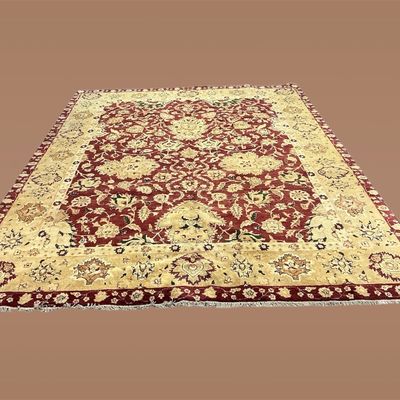 Ivory and burgundy traditional rug featuring a dramatic floral medallion surrounded by scrolling botanical motifs.