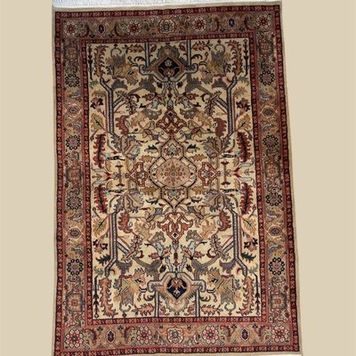 Warm gold, rust, burgundy, and ivory traditional rug featuring a dense floral and geometric pattern framed by multiple detailed borders.