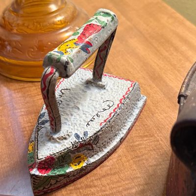 Vintage Hand-Painted Cast Iron Sad Iron Doorstop with Floral Motifs