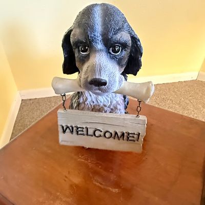 Resin Spaniel Dog Holding Welcome Bone Statue