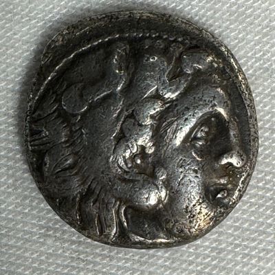Ancient Silver Coin with Seated Figure