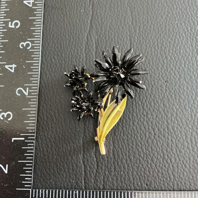 Vintage black and green enamel flower brooch