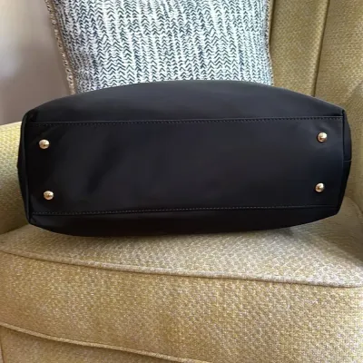 Sale Photo Thumbnail #18: This bag is the Michael Kors Colgate Large Tote Crossbody, a versatile piece crafted from durable black nylon with elegant Saffiano leather trim. [ NWOT]

Key Features Design: Features an East/West silhouette with a top zip closure.

Hardware: Accented wi
