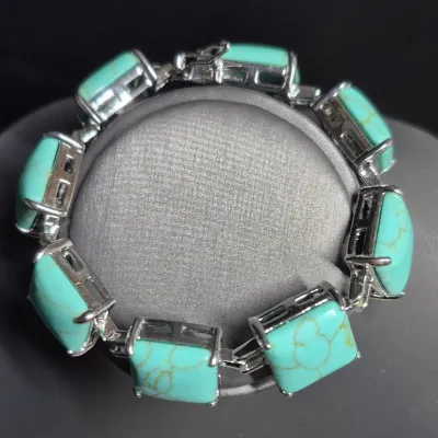 Sale Photo Thumbnail #25: Designer Silver Tone & Faux Turquoise Square Panel 7” Bracelet!

This auction is for a lovely bracelet. This measures 7” by ½" and has a weight of 32 grams. Super cute.