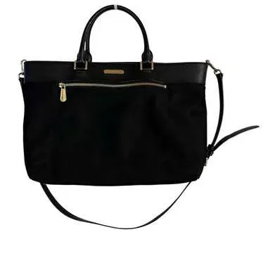 Sale Photo Thumbnail #14: This bag is the Michael Kors Colgate Large Tote Crossbody, a versatile piece crafted from durable black nylon with elegant Saffiano leather trim. [ NWOT]

Key Features Design: Features an East/West silhouette with a top zip closure.

Hardware: Accented wi