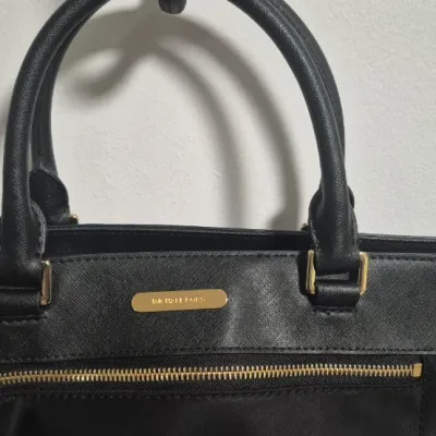 Sale Photo Thumbnail #17: This bag is the Michael Kors Colgate Large Tote Crossbody, a versatile piece crafted from durable black nylon with elegant Saffiano leather trim. [ NWOT]

Key Features Design: Features an East/West silhouette with a top zip closure.

Hardware: Accented wi