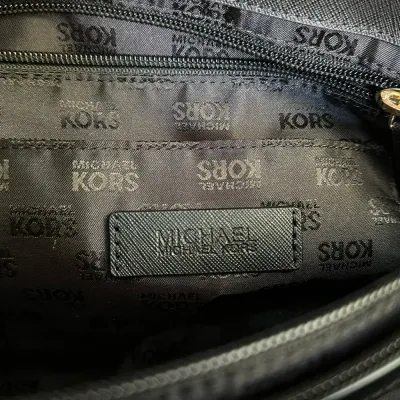 Sale Photo Thumbnail #20: This bag is the Michael Kors Colgate Large Tote Crossbody, a versatile piece crafted from durable black nylon with elegant Saffiano leather trim. [ NWOT]

Key Features Design: Features an East/West silhouette with a top zip closure.

Hardware: Accented wi