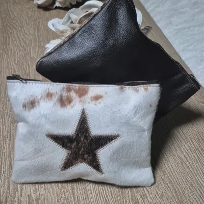 Sale Photo Thumbnail #5: Pair custom Cowhide Cosmetic Bags ~ Cowhide fronts / leather backs
< perfect for storing all your cosmetic essentials.
Made from durable grade A cowhide.
< one with Star / other cowhide grain....
> zipper tops Size: 9 x 7