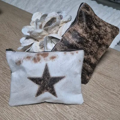 Sale Photo Thumbnail #6: Pair custom Cowhide Cosmetic Bags ~ Cowhide fronts / leather backs
< perfect for storing all your cosmetic essentials.
Made from durable grade A cowhide.
< one with Star / other cowhide grain....
> zipper tops Size: 9 x 7