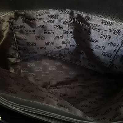 Sale Photo Thumbnail #19: This bag is the Michael Kors Colgate Large Tote Crossbody, a versatile piece crafted from durable black nylon with elegant Saffiano leather trim. [ NWOT]

Key Features Design: Features an East/West silhouette with a top zip closure.

Hardware: Accented wi