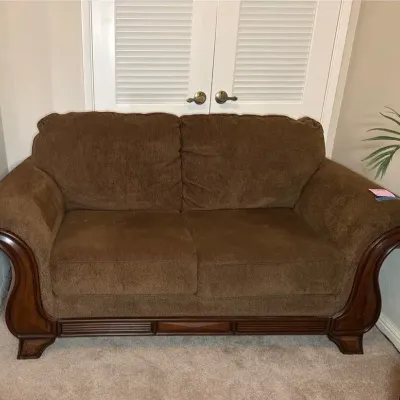 Ashley Furniture Textured Fabric Loveseat With Carved Wood Trim 60x35.5x34