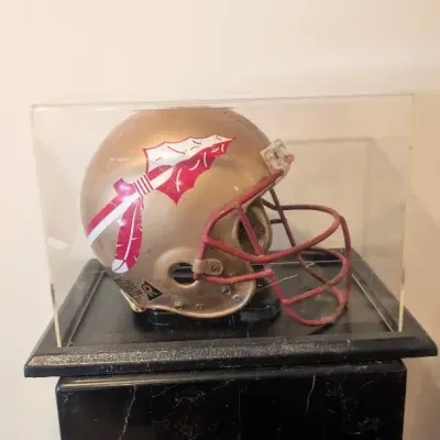 Vintage Florida State Seminoles Football Helmet safely housed inside an acrylic display case