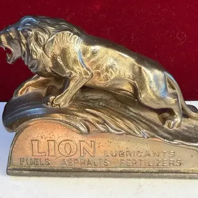 Sale Photo Thumbnail #31: Lion oil company metal paperweight