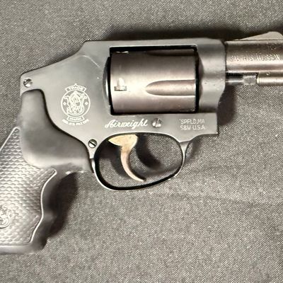 Sale Photo Thumbnail #422: This revolver is perfect for concealed carry. It is a lightweight five-round double action snub nosed revolver chambered in .38 special +P, with an enclosed snag-free hammer. Its weight is only 14.6 ounces (unloaded). It has a blued finish, and hard rubbe