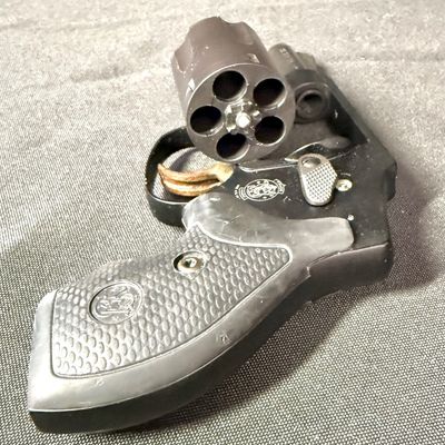 Sale Photo Thumbnail #425: This revolver is perfect for concealed carry. It is a lightweight five-round double action snub nosed revolver chambered in .38 special +P, with an enclosed snag-free hammer. Its weight is only 14.6 ounces (unloaded). It has a blued finish, and hard rubbe