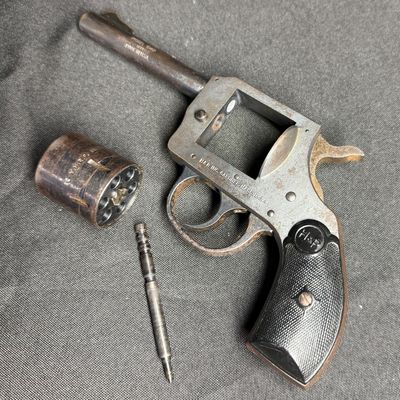 Sale Photo Thumbnail #417: This is a vintage six-shot double action rimfire revolver. It is chambered for .22 Winchester magnum rimfire. It has a four-inch barrel, and hard plastic grips. It has a parkerized frame with blued cylinder and barrel. These revolvers were produced betwee