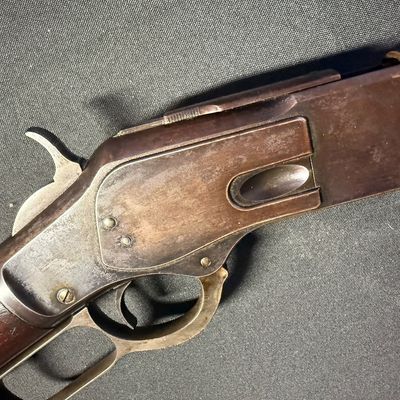 Sale Photo Thumbnail #450: This beautiful lever-action carbine is widely known as “The Gun That Won the West.” It features a 20-inch barrel, and holds 15 rounds of ammunition. It fires .44 Winchester Center Fire (.44-40) caliber ammo, a revolutionary round that could be used in