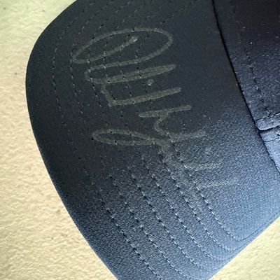 Sale Photo Thumbnail #430: This is a Callaway brand cap. The autograph is on the brim, in what appears to be metallic Sharpie, or other marker. This piece has not been authenticated. The size is believed to be large. Pre-auction estimate: $150-$300.