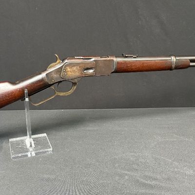 Sale Photo Thumbnail #445: This beautiful lever-action carbine is widely known as “The Gun That Won the West.” It features a 20-inch barrel, and holds 15 rounds of ammunition. It fires .44 Winchester Center Fire (.44-40) caliber ammo, a revolutionary round that could be used in