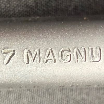 Sale Photo Thumbnail #413: This is a very nice matte stainless steel seven-shot, double action revolver. It fires .357 mag or .38 special (+P) ammo. It has a four-inch barrel, and soft rubber grips. It has a fixed front ramp and adjustable rear sight. It has a ported barrel to redu