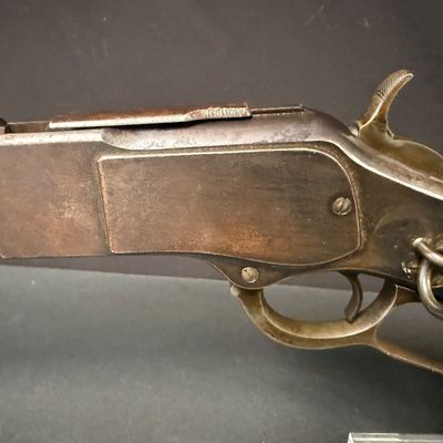 Sale Photo Thumbnail #447: This beautiful lever-action carbine is widely known as “The Gun That Won the West.” It features a 20-inch barrel, and holds 15 rounds of ammunition. It fires .44 Winchester Center Fire (.44-40) caliber ammo, a revolutionary round that could be used in