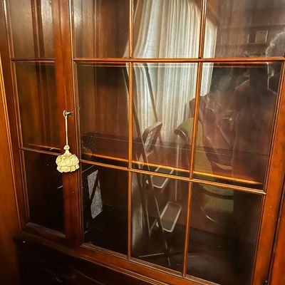 Sale Photo Thumbnail #31: traditional dark mahogany china cabinet featuring glass-paneled upper doors and multiple lower storage drawers.