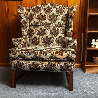 Sale Photo Thumbnail #24: Vintage clean floral upholstered chair. Features traditional high back flared wings and dark wooded legs.