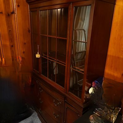 Sale Photo Thumbnail #30: traditional dark mahogany china cabinet featuring glass-paneled upper doors and multiple lower storage drawers.