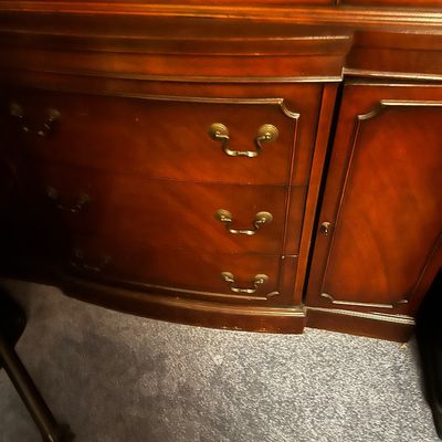 Sale Photo Thumbnail #33: traditional dark mahogany china cabinet featuring glass-paneled upper doors and multiple lower storage drawers.