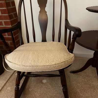 Sale Photo Thumbnail #16: Windsor style rocking chair with a high spindle back, decorative center spat, and a light color upholstered cushion.