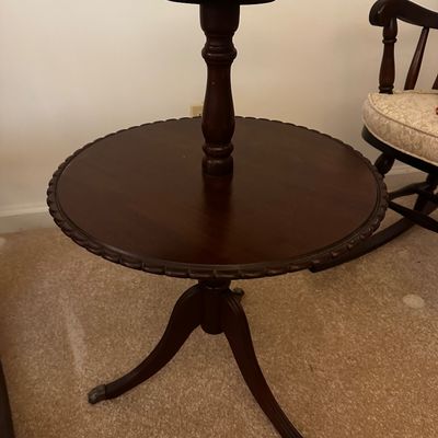 Sale Photo Thumbnail #18: Vintage two tier mahogany pie crust side table featuring a distinctive scalloped edge and a carved tripod base.
