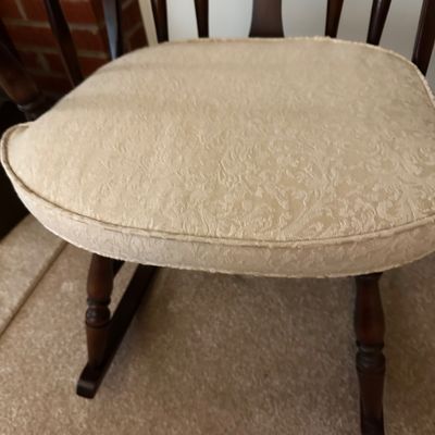 Sale Photo Thumbnail #17: Windsor style rocking chair with a high spindle back, decorative center spat, and a light color upholstered cushion.