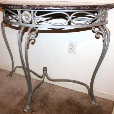 Half-Circle Console Table
$100.00
38.5in x 16.5in. x 32in.

- Dark Faux Marble Top
- Silver-tone Metal Base
- Decorative Rosette Accents