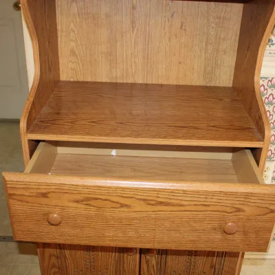 Oak Microwave Stand
$25.00
26in x 17in. x 48in. 
Comes with upper shelf, a single drawer, and lower cabinet storage.
