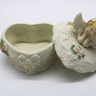 Vintage Heart-Shaped Porcelain Trinket Box w/ Lid
$30.00
- Embossed Lattice Pattern
- Pink Rose Accents
- Sculpted Cherub Angel Lid