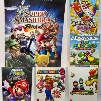 (6) Mario Game Guides Including Smash Bros, Wario & More