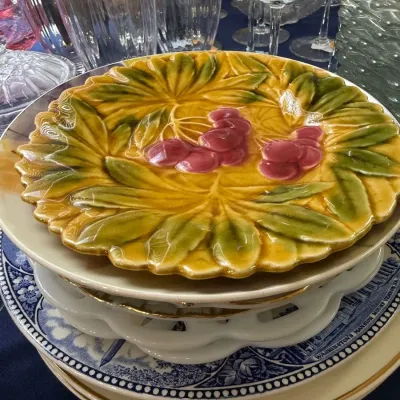 Majolica style grape leaf plate on transferware stack