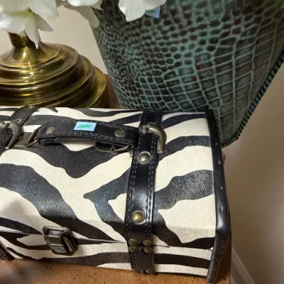 Zebra print studded travel trunk