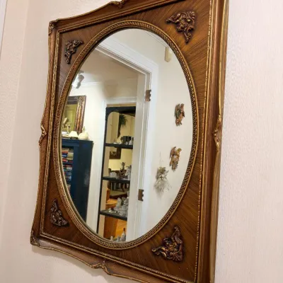 Ornate gilt wood oval wall mirror
