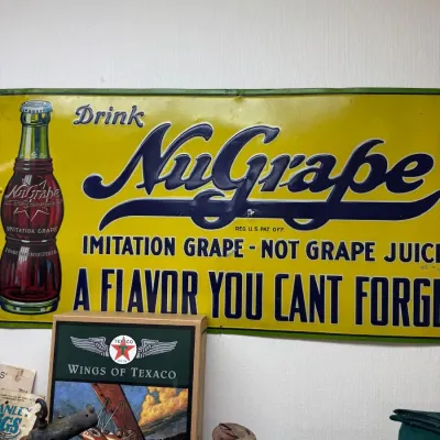 Drink NuGrape metal advertising sign