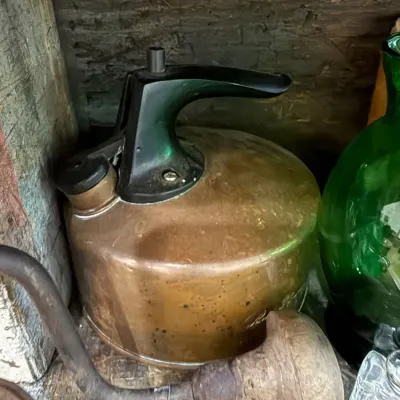 Antique copper tea kettle with black handle