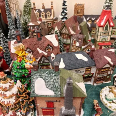 Christmas village buildings with bottle brush trees