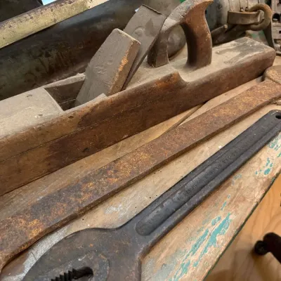 Antique wooden jointer plane and iron wrenches