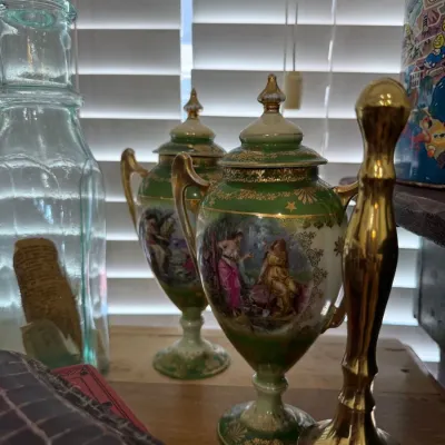 Pair of green and gilt hand-painted portrait urns